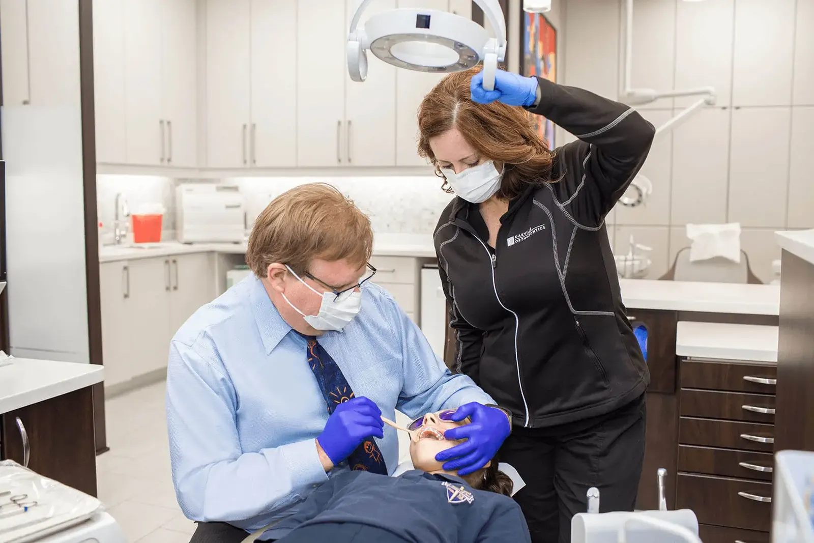 Dr. Gwartz and an assistant caring for a patient