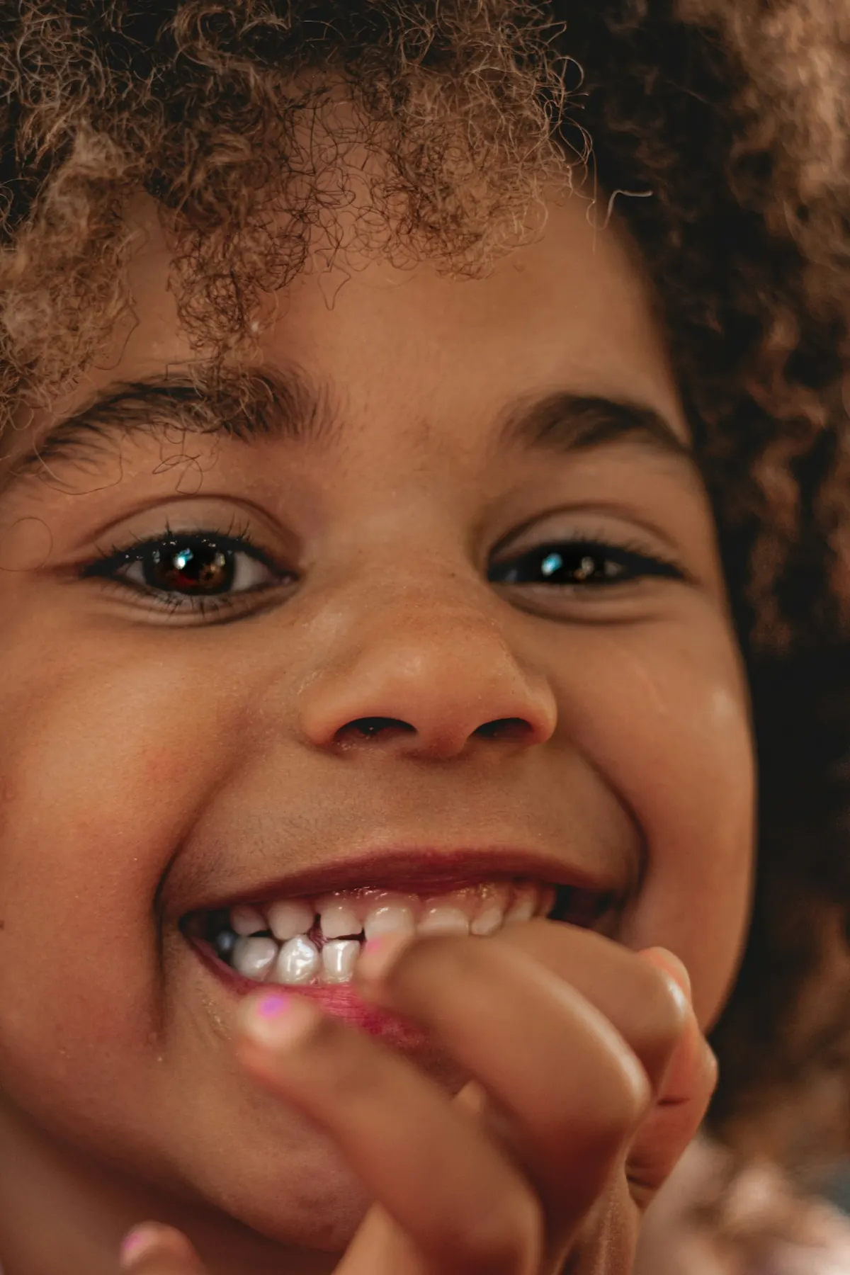 Young girl smiling and showing her teeth