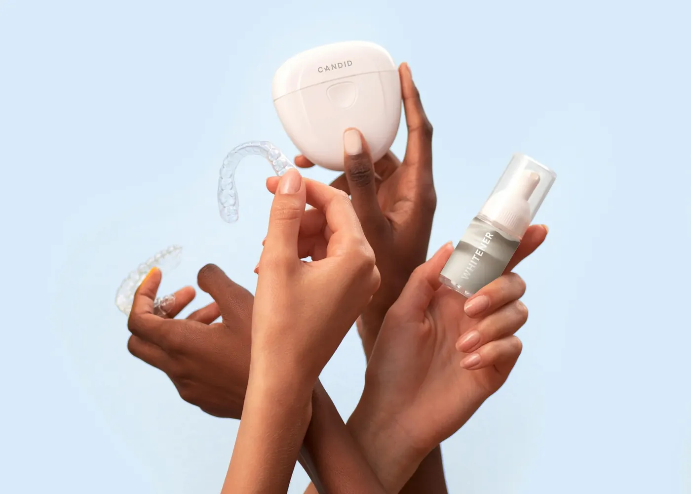 Hands holding clear retainers and a storage case
